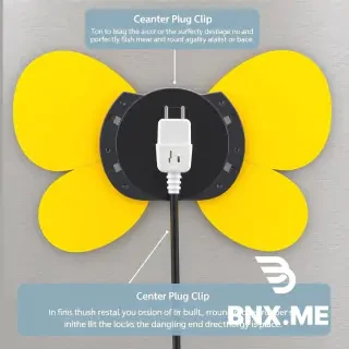 • The Flat Backing: The rear side of the anchor is a smooth, wide surface designed to lay perfectly flush against your appliance. This provides maximum surface area for the 3M adhesive tape to grip. • The Flared Butterfly Wings: Projecting outward from the base are two wide, curved tabs. These wings create a deep channel where you loop the cord around and around, keeping it tightly bound against the machine's body. • Center Plug Clip: The Center Plug Clip: In the absolute center of the mount—right between the two wings—is a built-in vertical friction slot or notch. When you finish wrapping the cord, you snap the thick, round rubber wire right before the plug head directly into this clip. This locks the dangling end securely in place.